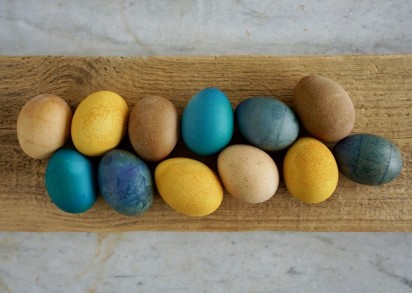 Naturfärgade ägg ligger upplagda på en bräda